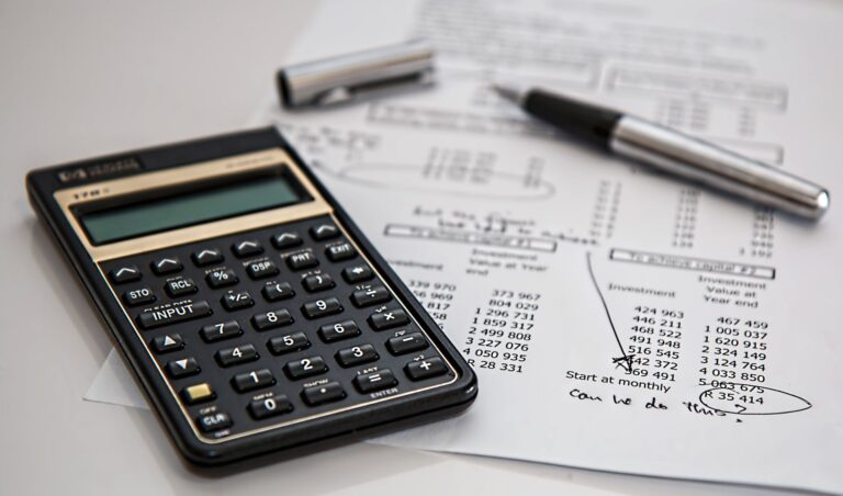 Close-up of financial documents with a calculator and pen
