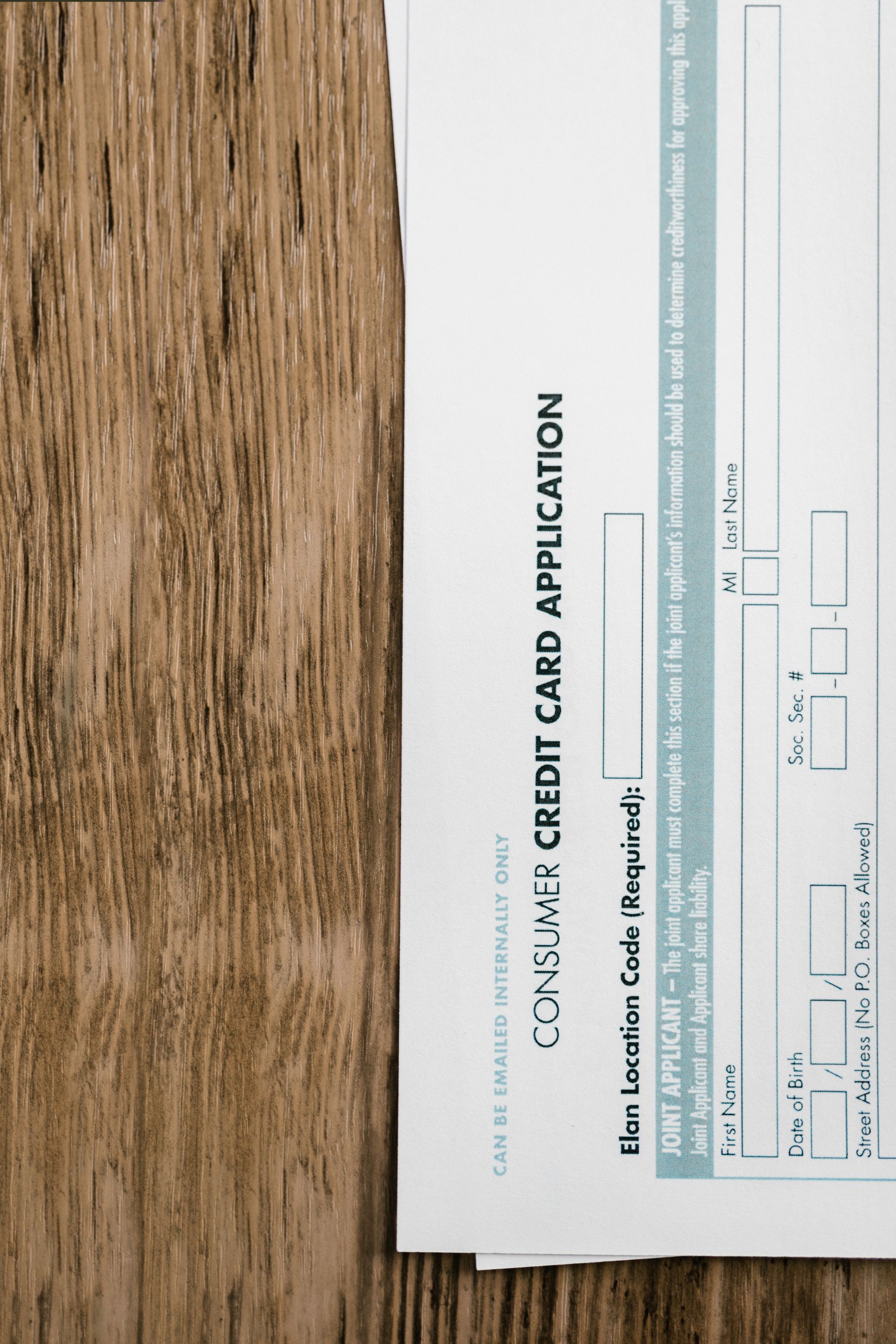 Close-up of a consumer credit application form on a wooden surface