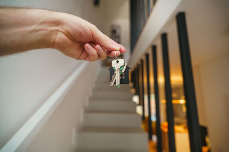 Hand holding house keys representing a new mortgage