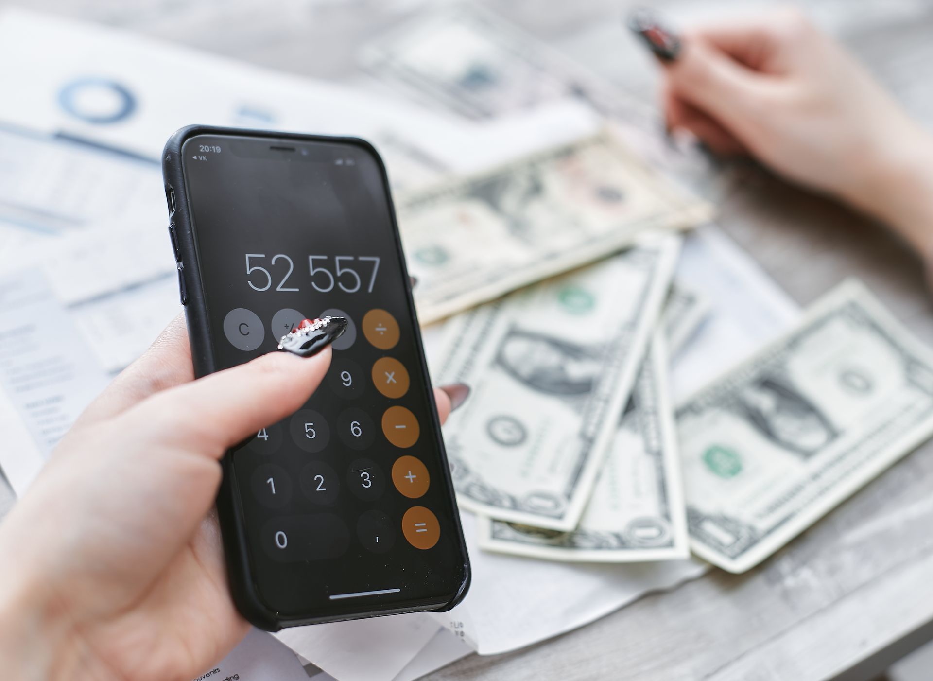 Person planning finances at a desk with calculator
