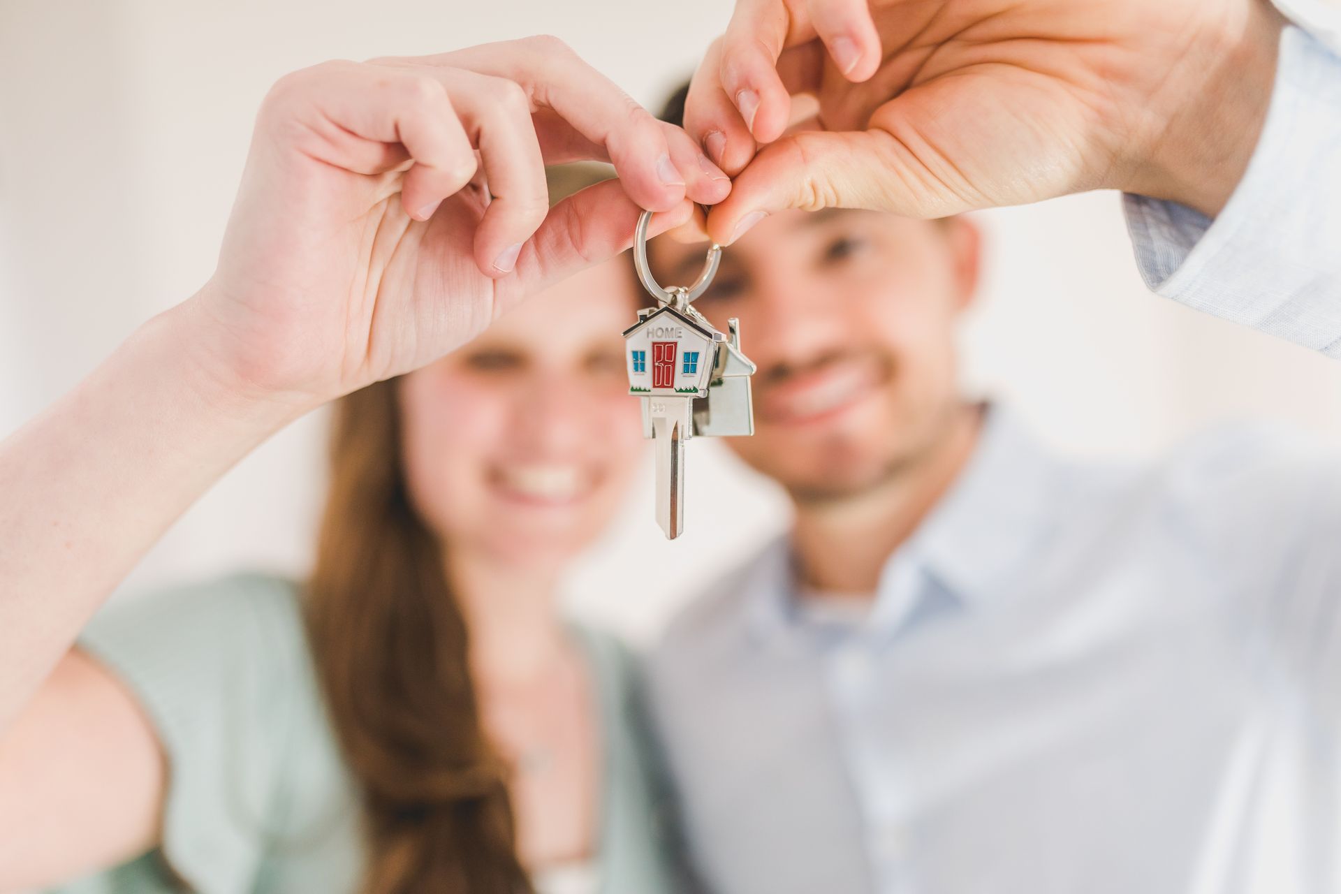 Young couple holding keys to their new home