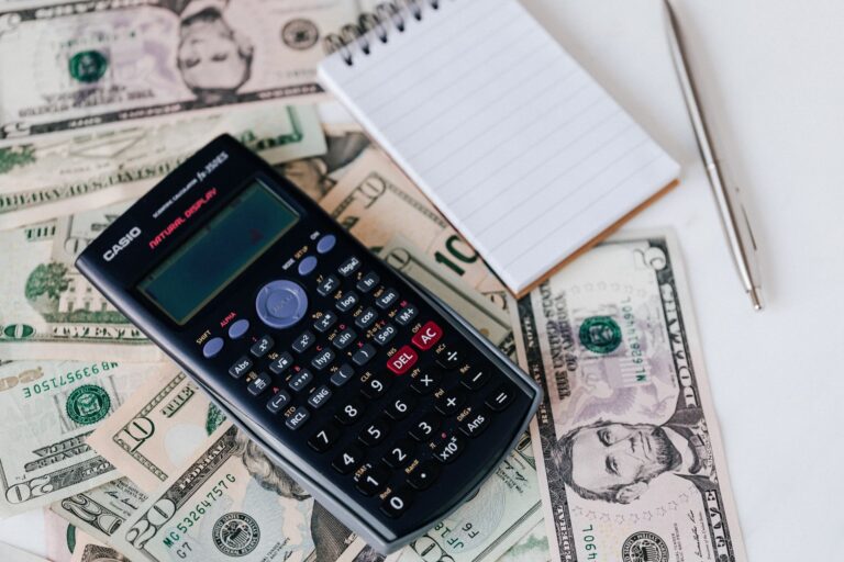 Calculator and financial documents for loan payment calculation