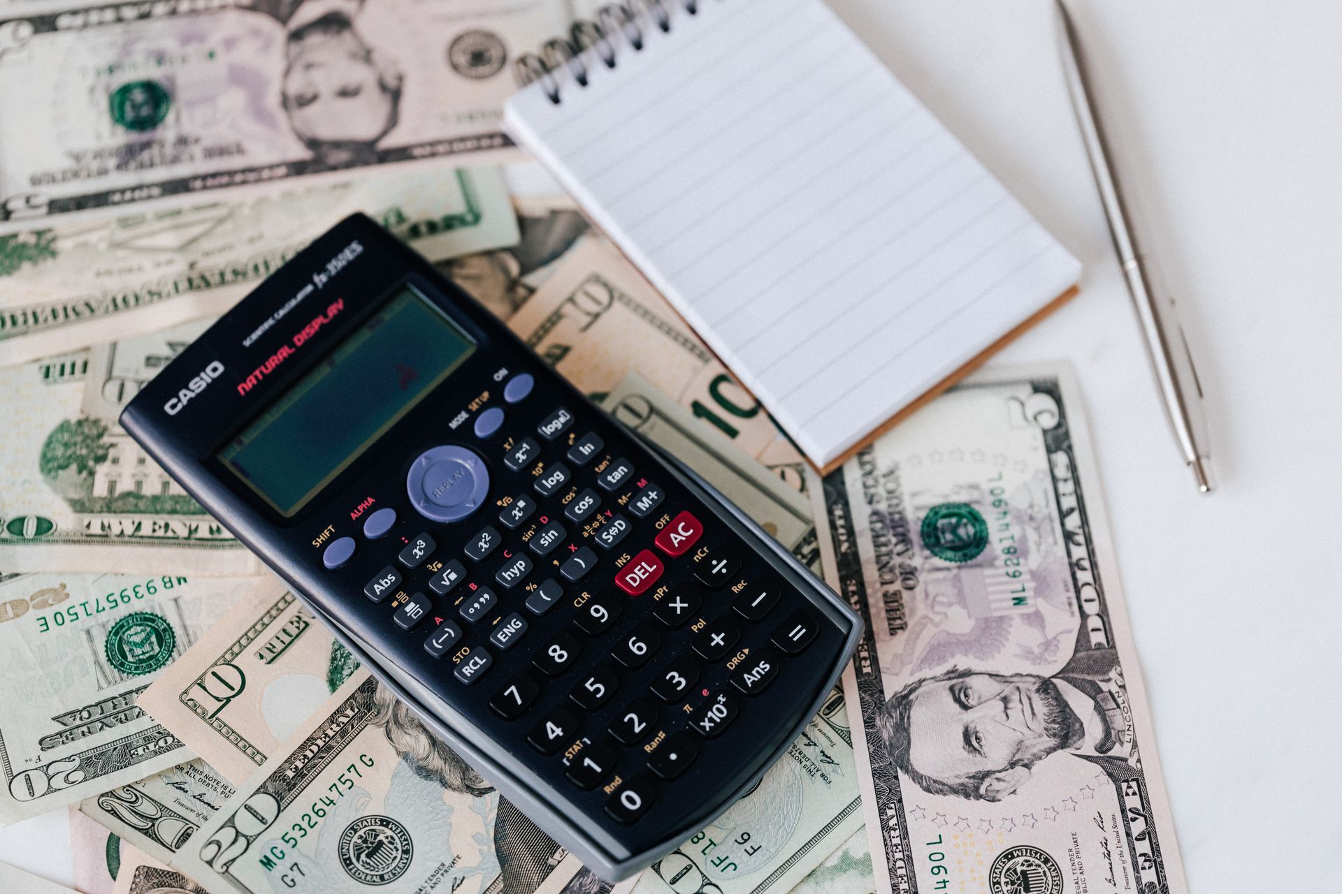 Calculator and financial documents for loan payment calculation