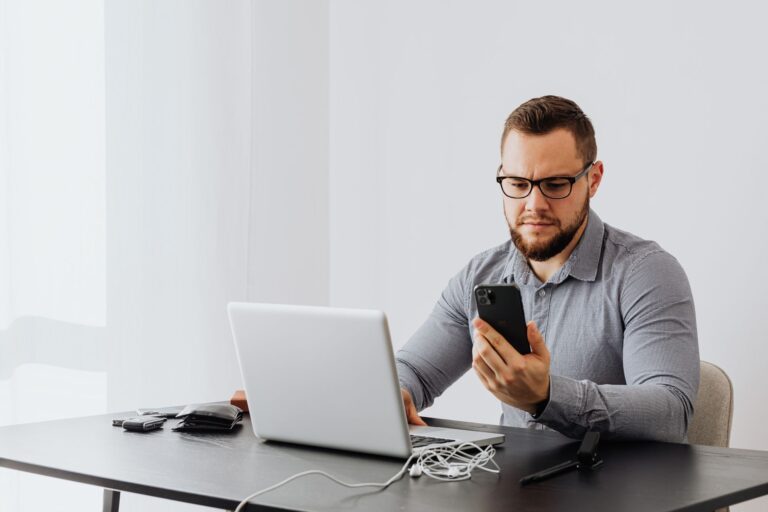 Business owner reviewing finances at a table with laptop