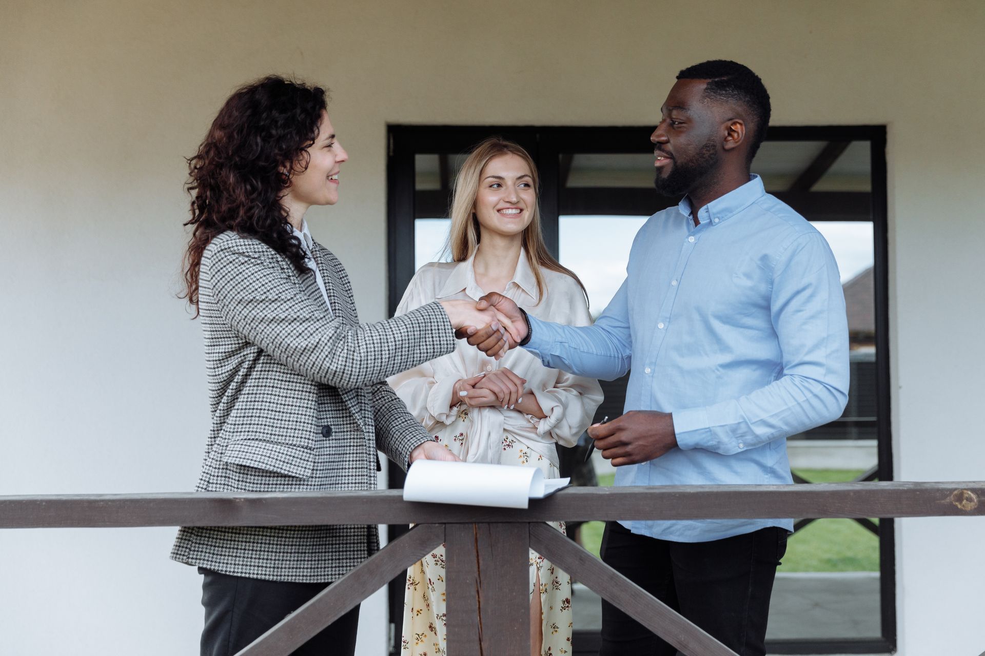 Real estate agent shaking hands with homebuyer