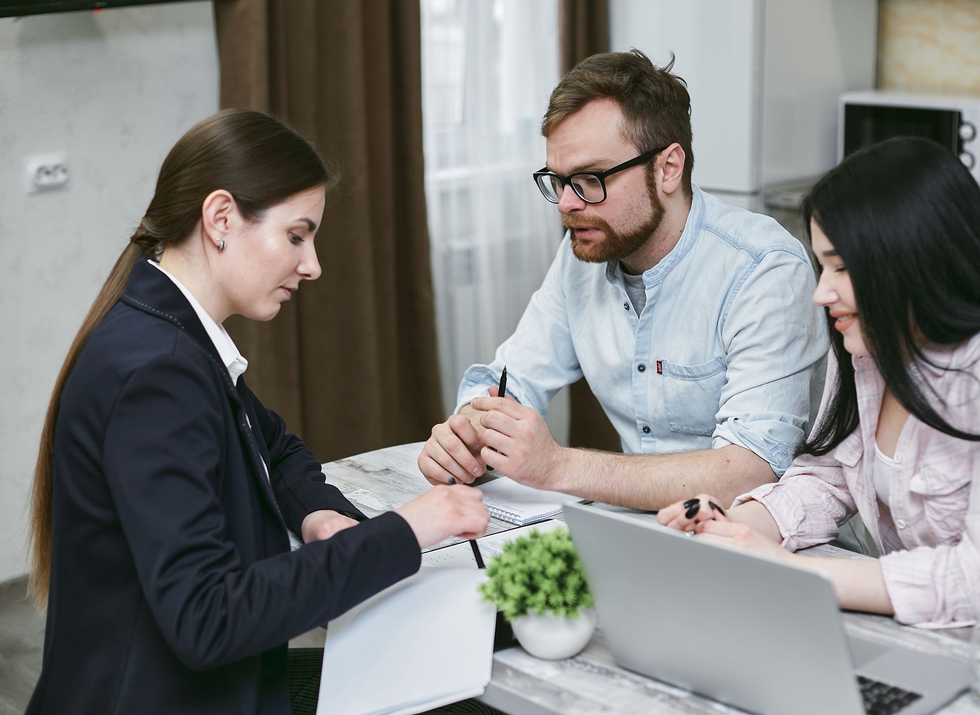 Small business owners discussing financial documents with their advisor