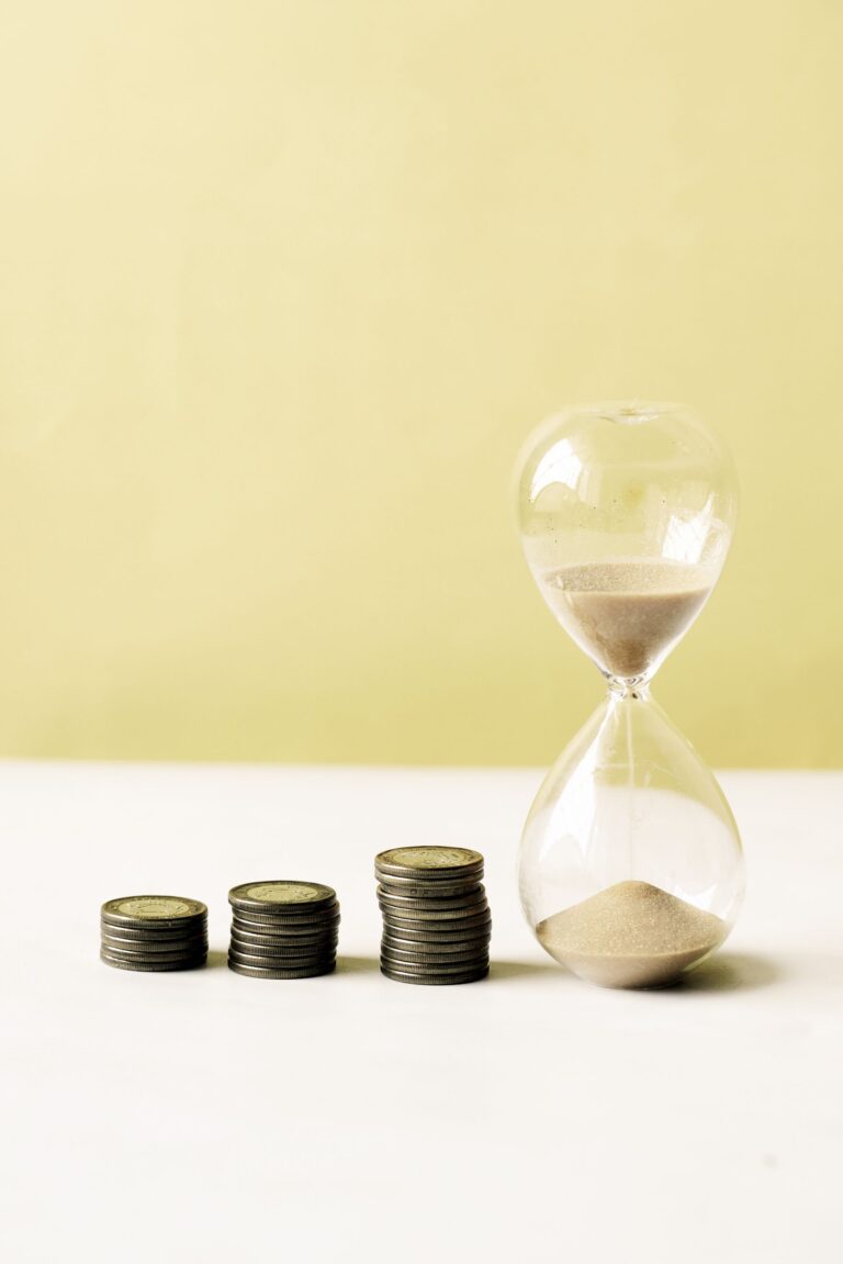 Hourglass with coins symbolizing time and money