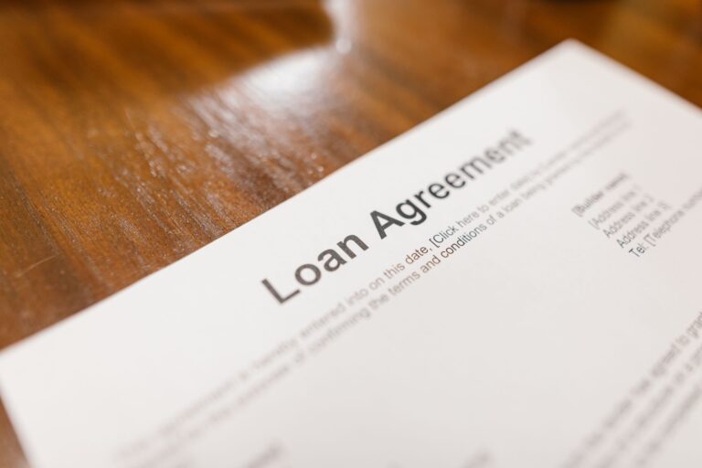 Close-up of a personal loan agreement document on a wooden table