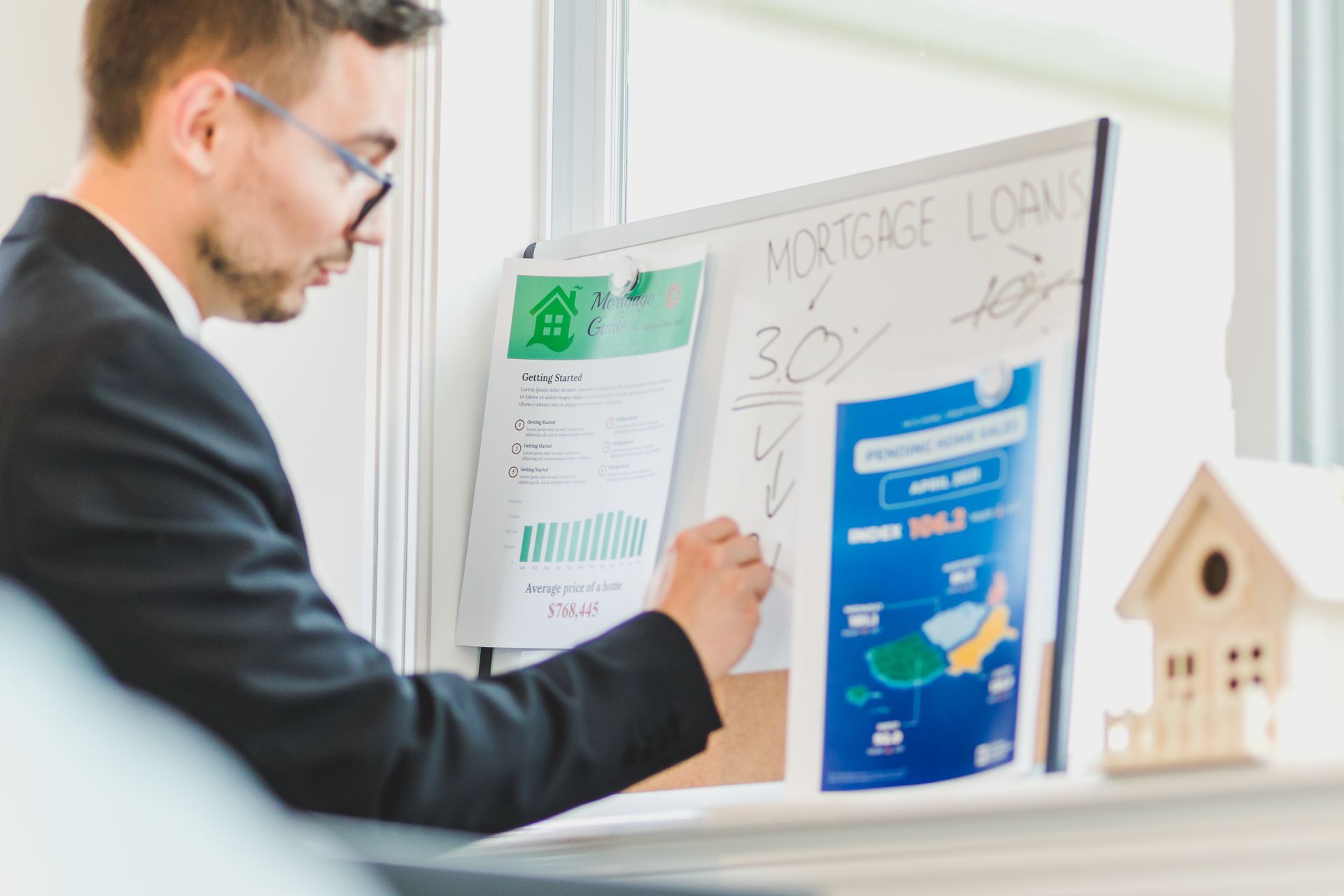 Real estate agent analyzing mortgage loan details on a whiteboard
