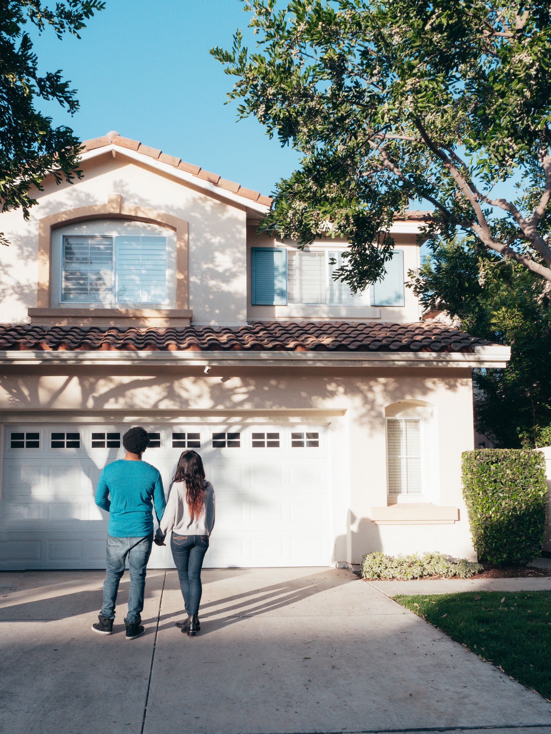 Couple admiring their new house after closing