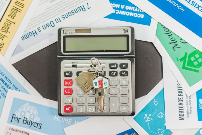 Calculator with house keys and real estate documents
