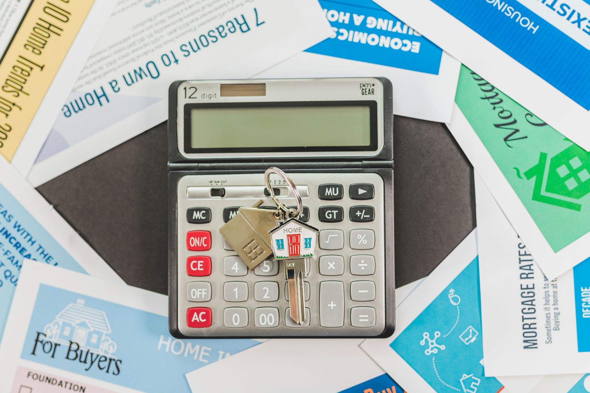 Calculator with house keys and real estate documents