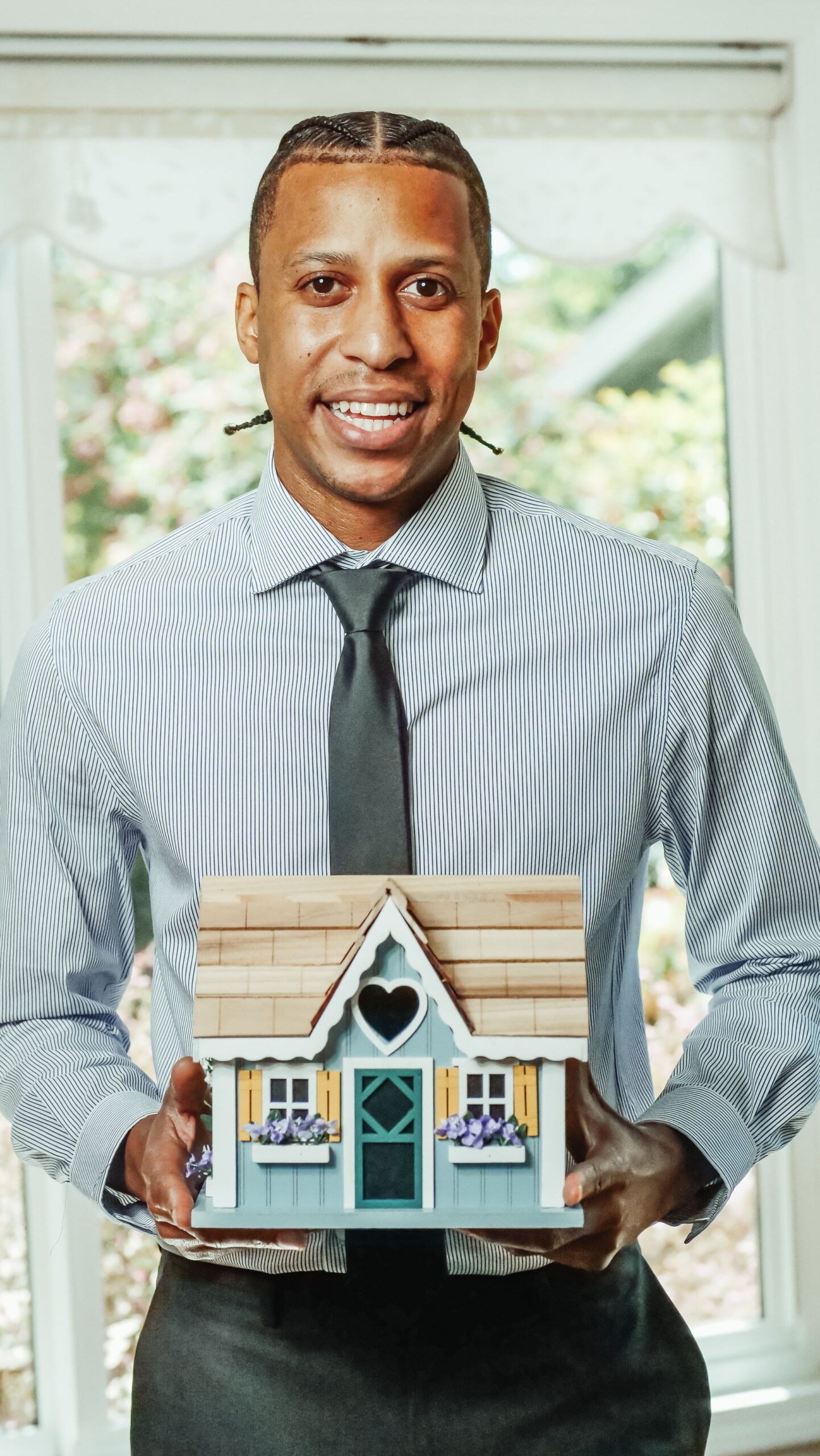 Real estate agent holding a miniature house model