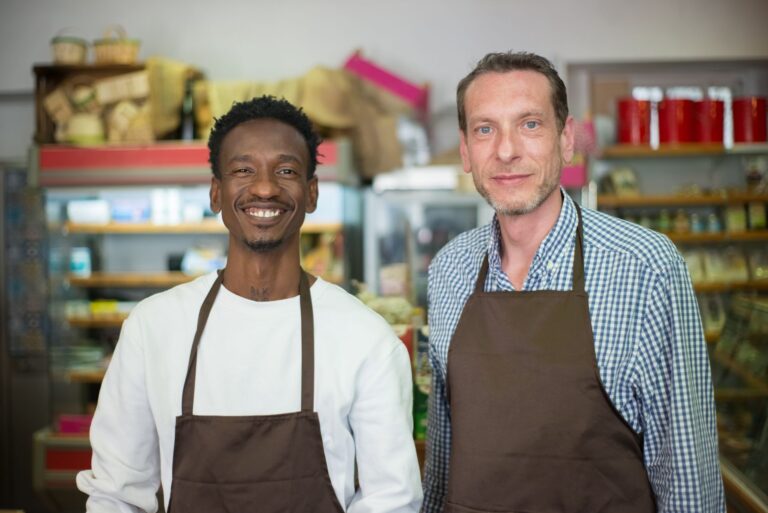 Two happy small business owners in a local grocery store