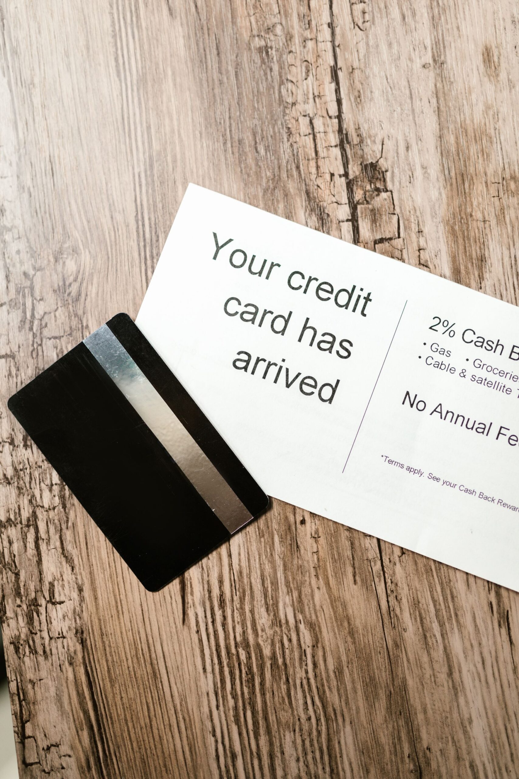 Credit card and welcome letter on a wooden table