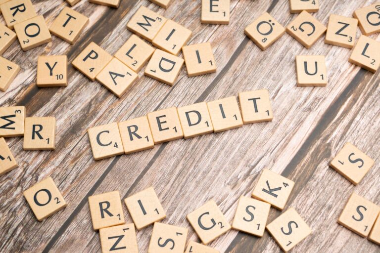 Wooden letter tiles spelling CREDIT representing credit score and credit report