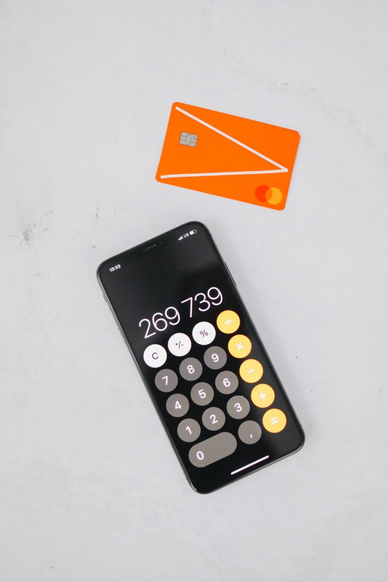 Smartphone showing a calculator app next to a credit card