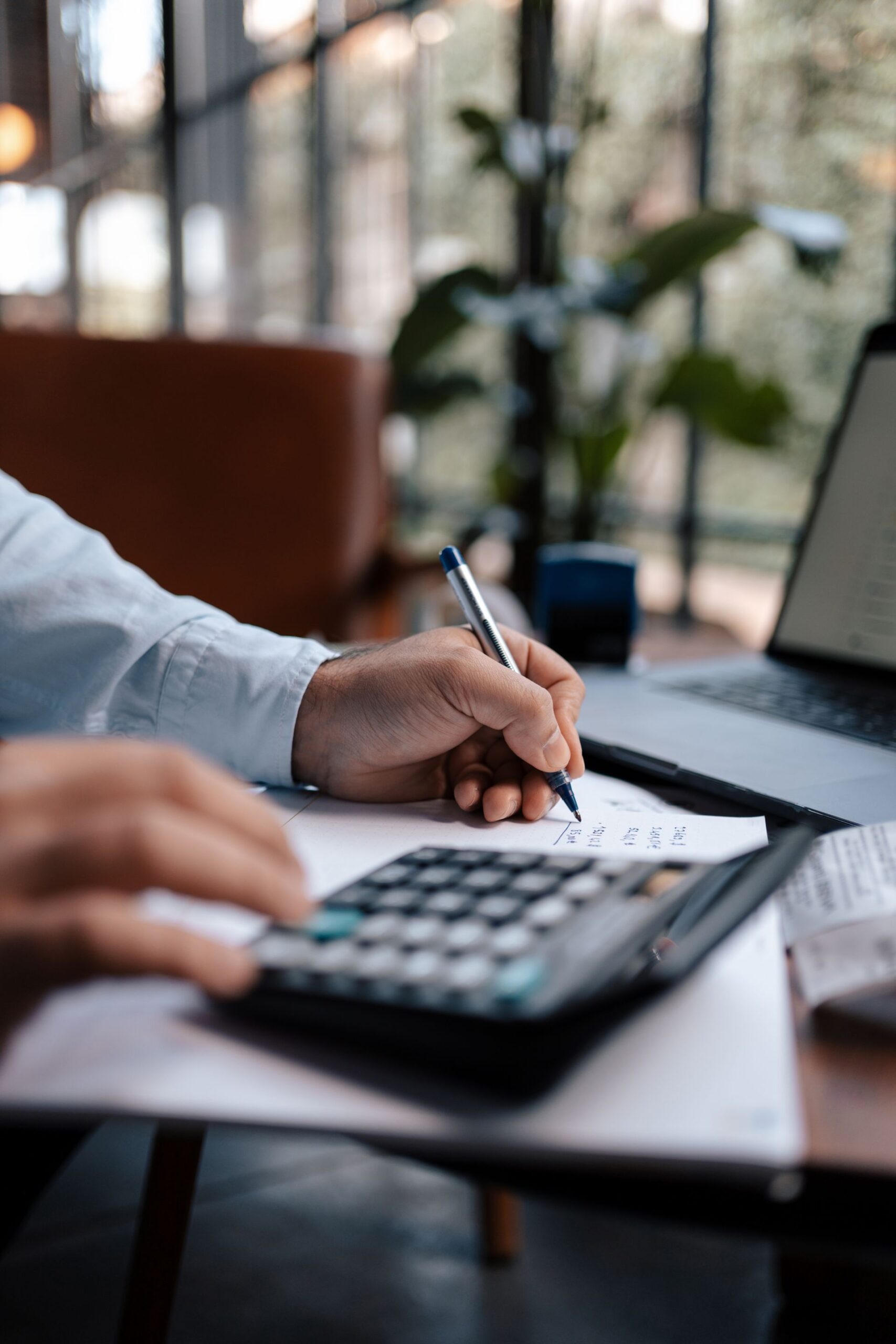 Person using a calculator for payment planning