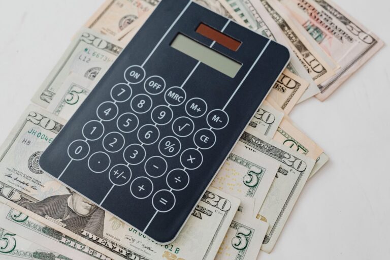 Calculator on top of US dollar bills for financial planning