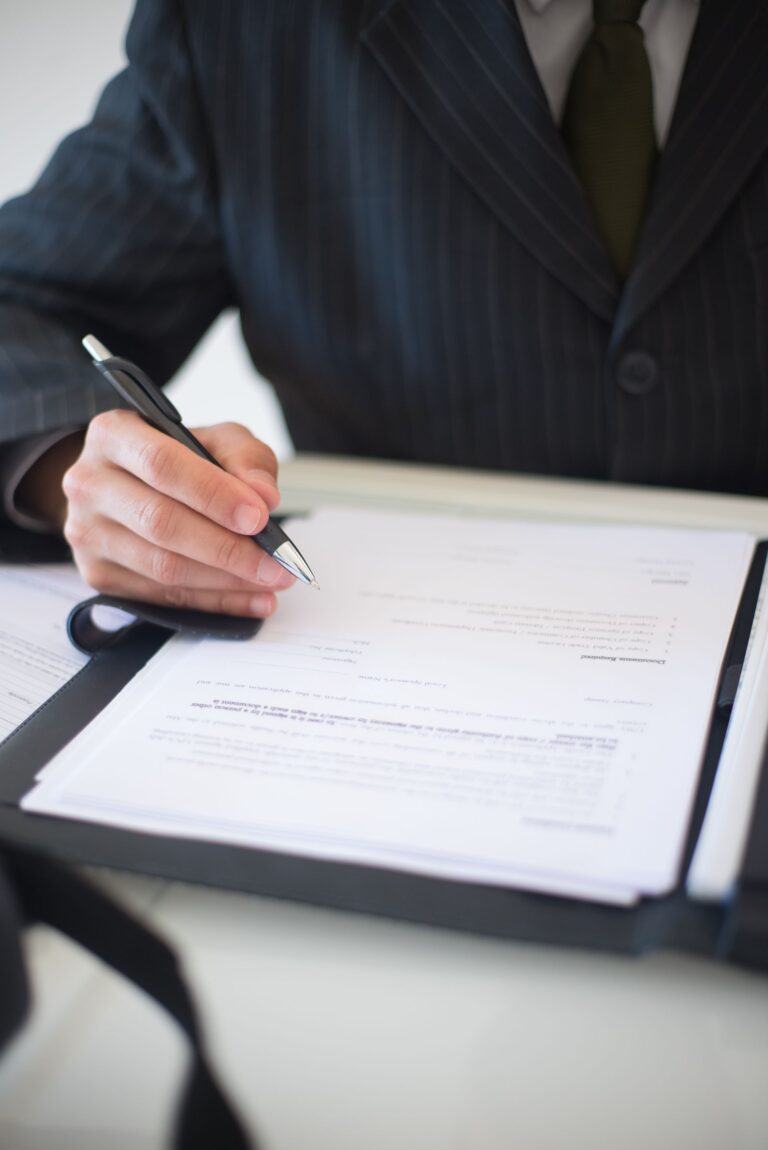 Close-up of a business professional signing loan documents