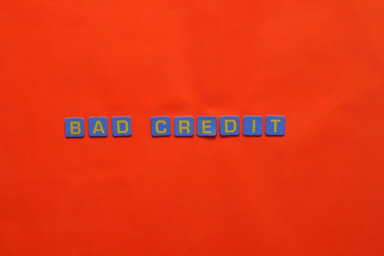 Letter blocks spelling bad credit on an orange background