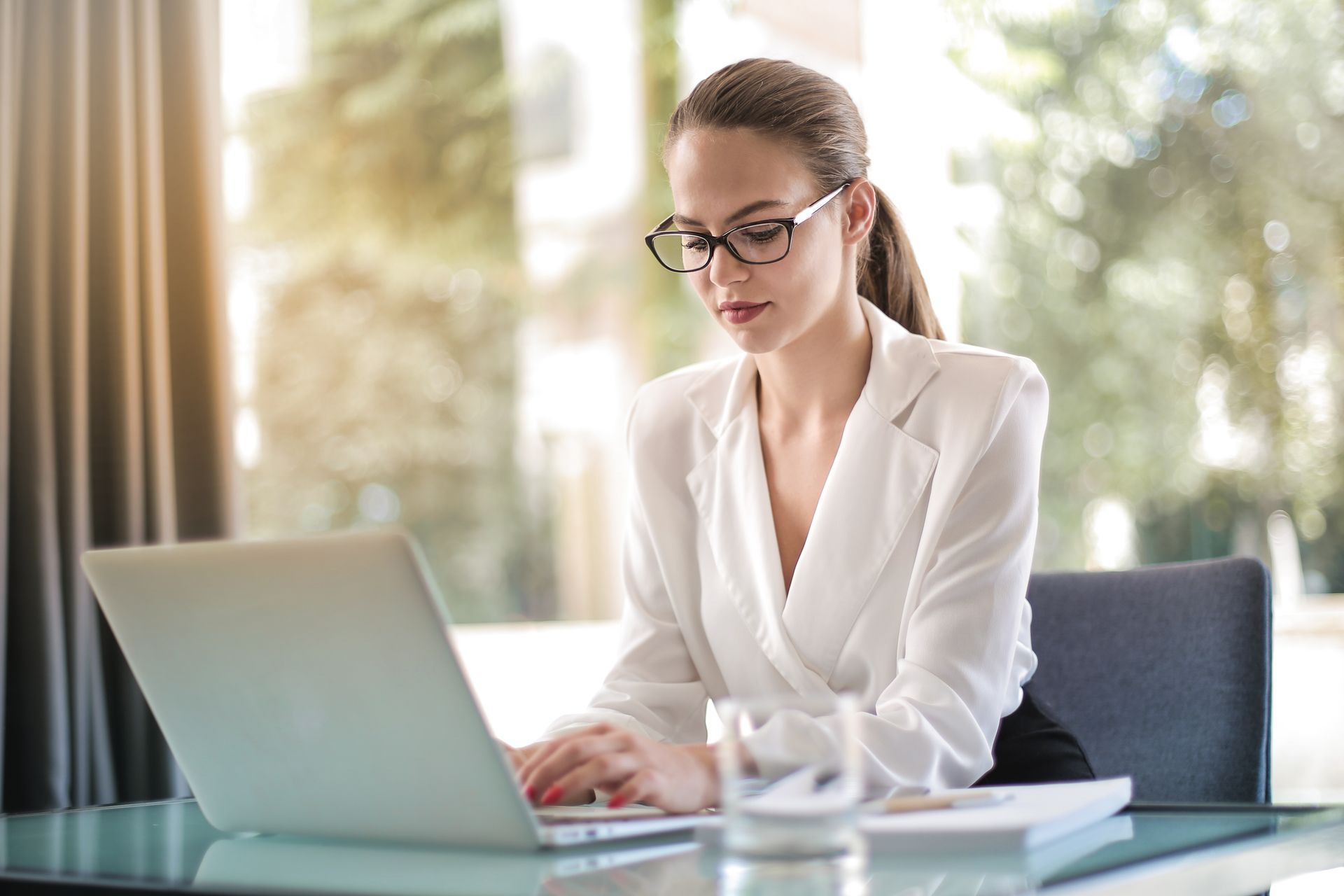 Focused businesswoman working on a laptop at her office desk