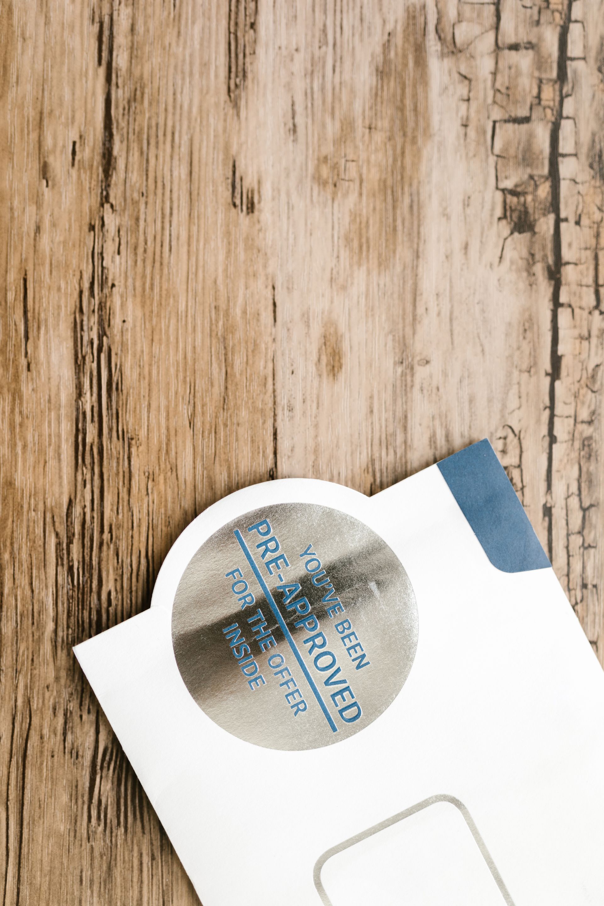 A pre-approved offer envelope with a sticker on a rustic wooden surface